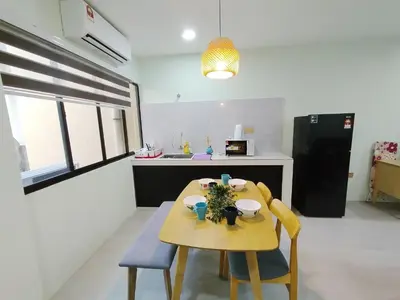 a kitchen with a small table and chairs in a room at Dim Sum Homestay in Ipoh