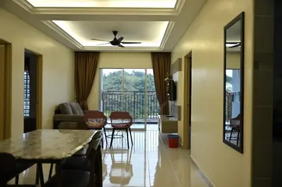 a living room with a ceiling fan and a table at Emerald Avenue Apartment Madam Ng. in Cameron Highlands