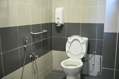 a bathroom with a toilet and a shower at Emerald Avenue Apartment Madam Ng. in Cameron Highlands