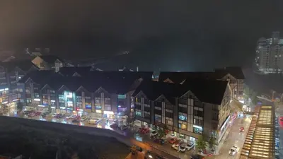 a group of buildings with lights at night at Emerald Avenue Apartment Madam Ng. in Cameron Highlands