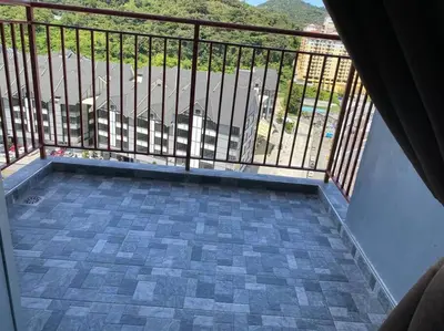 a balcony with a view of a parking lot at Emerald Avenue Apartment Madam Ng. in Cameron Highlands