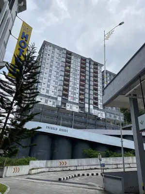 a large building with a sign in front of it at Emerald Avenue Apartment Madam Ng. in Cameron Highlands