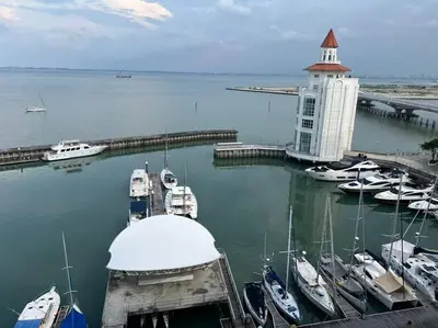 a group of boats docked in a marina with a building at Perfect Marina Stay@ Strait Quay 5 pax w/ Free Carpark in Bagan Jermal