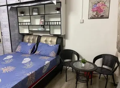 a room with a bed and a table with chairs at Homestay Idaman Private Pool Mslim in Kuala Kangsar