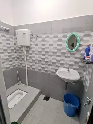 a bathroom with a sink and a toilet and a mirror at Homestay Idaman Private Pool Mslim in Kuala Kangsar