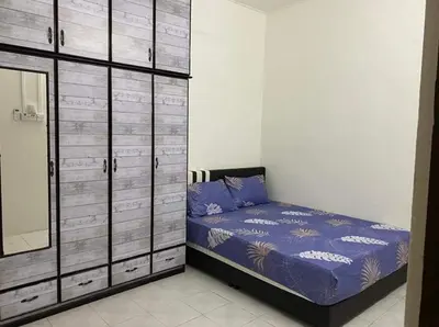 a bedroom with a bed and a mirror and cabinets at Homestay Idaman Private Pool Mslim in Kuala Kangsar