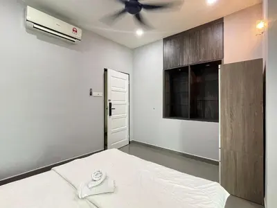 a bedroom with a bed and a ceiling fan at MR Homestay HotelStyle Room Teluk Intan in Teluk Intan