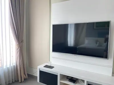 a flat screen tv sitting on a stand in a room at MR Homestay HotelStyle Room Teluk Intan in Teluk Intan
