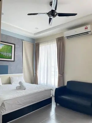 a bedroom with a bed and a blue chair at MR Homestay HotelStyle Room Teluk Intan in Teluk Intan
