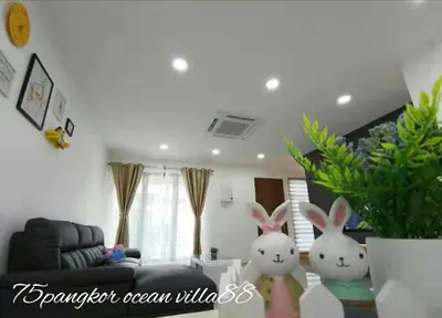 two stuffed rabbits are standing in a living room at 75 pangkor ocean in Pangkor