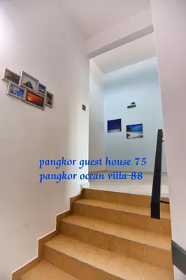 a staircase in a house with a sign on the wall at 75 pangkor ocean in Pangkor