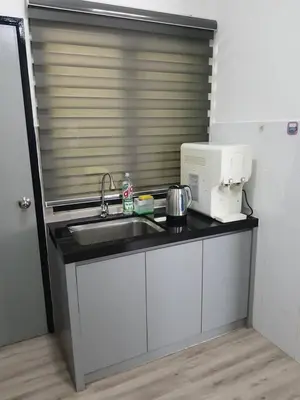 a kitchen counter with a sink and a microwave at 75 pangkor ocean in Pangkor