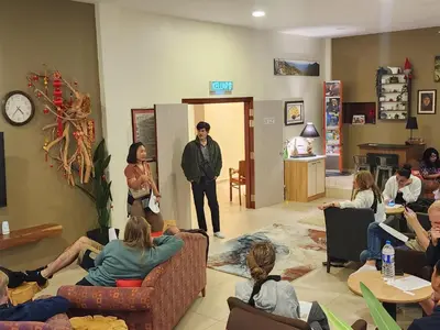 a man standing in a room with a group of people at Fathers Guesthouse Age 7 years old and above only in Tanah Rata