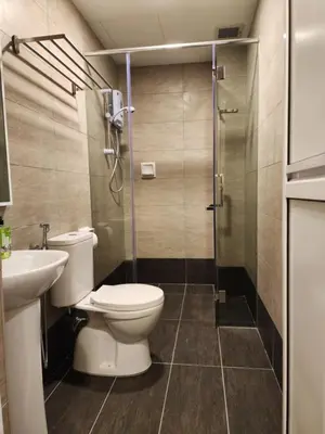 a bathroom with a toilet and a shower at Fathers Guesthouse Age 7 years old and above only in Tanah Rata
