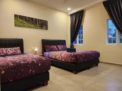 a bedroom with two beds and a window at Fathers Guesthouse Age 7 years old and above only in Tanah Rata