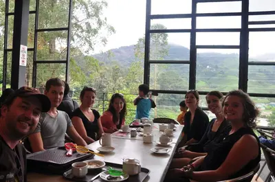 a group of people sitting at a table in a restaurant at Fathers Guesthouse Age 7 years old and above only in Tanah Rata