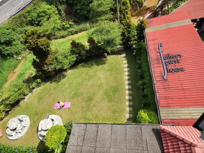 an overhead view of a garden with a person laying on the grass at Fathers Guesthouse Age 7 years old and above only in Tanah Rata