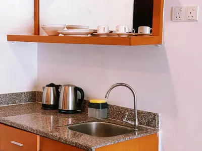 a kitchen counter with a sink and a shelf at NOVA Apartment at Cameron in Cameron Highlands
