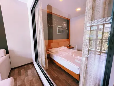 a small bedroom with a bed and a window at NOVA Apartment at Cameron in Cameron Highlands