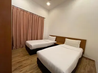 a hotel room with two beds and a window at NOVA Apartment at Cameron in Cameron Highlands