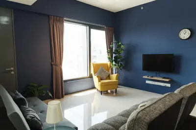 a blue living room with a couch and a tv at The CEDAR, 2BR Cityview by WStay @ Tropicana 218 Macalister in George Town