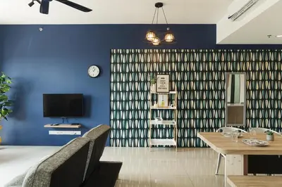 a living room with a table and a blue wall at The CEDAR, 2BR Cityview by WStay @ Tropicana 218 Macalister in George Town