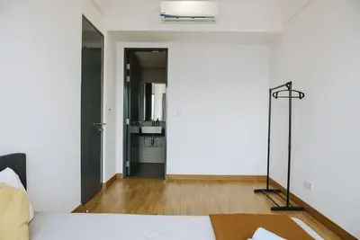 a bedroom with a white bed and a bathroom at The WHITE, 2BR Cityview by WStay @ Tropicana 218 Macalister in George Town
