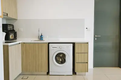 a kitchen with a washing machine under a counter at The WHITE, 2BR Cityview by WStay @ Tropicana 218 Macalister in George Town