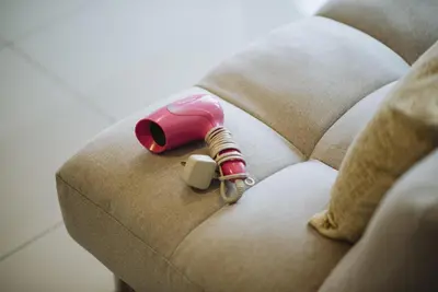 a pink bottle sitting on top of a couch at The WHITE, 2BR Cityview by WStay @ Tropicana 218 Macalister in George Town