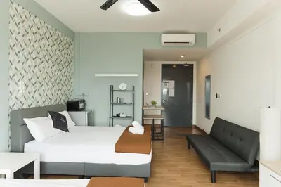 a living room with a bed and a couch at The WILLOW, Studio Cityview by WStay @ Tropicana 218 Macalister in George Town