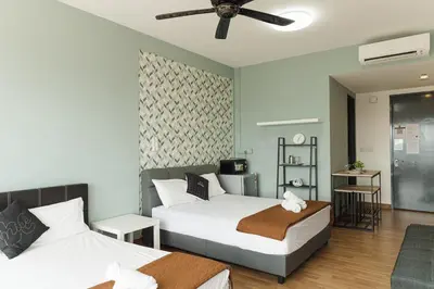 a hotel room with two beds and a ceiling fan at The WILLOW, Studio Cityview by WStay @ Tropicana 218 Macalister in George Town