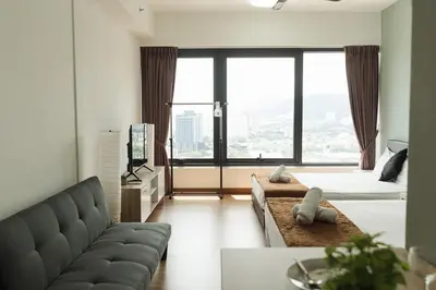 a living room with a couch and a large window at The WILLOW, Studio Cityview by WStay @ Tropicana 218 Macalister in George Town