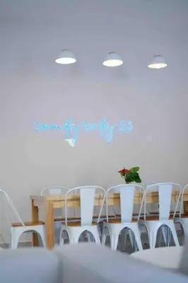 a table and chairs in a white room with a table at Comfy Sofy 23- Balcony Garden (Night market) in Tanah Rata
