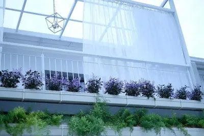 a balcony with purple flowers on a building at Comfy Sofy 23- Balcony Garden (Night market) in Tanah Rata