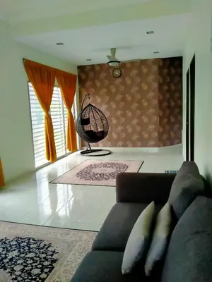 a living room with a couch and a chair at Homestay Haji Din Tronoh Perak in Teronoh