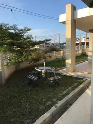 a picnic table and two benches in a yard at Fidaiy Homestay in Teronoh