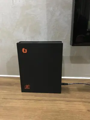 a black box sitting on top of a wooden floor at Fidaiy Homestay in Teronoh