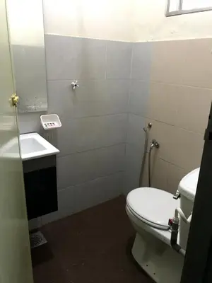a bathroom with a toilet and a sink at Fidaiy Homestay in Teronoh