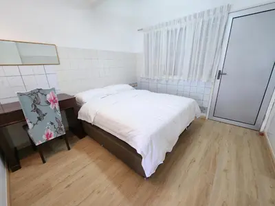 a bedroom with a bed and a desk and a window at Little England B3 in Bukit Fraser