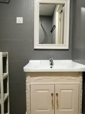 a bathroom with a white sink and a mirror at High floor Mountain view Kampar in Kampar
