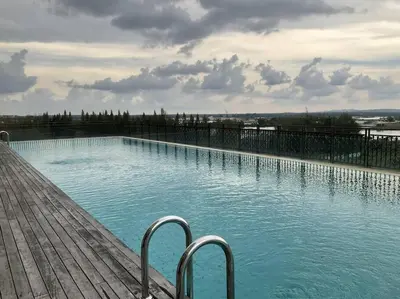 a large swimming pool with blue water and metal rails at High floor Mountain view Kampar in Kampar