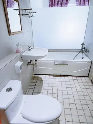 a bathroom with a toilet and a sink and a tub at The Ipoh All Suite Resort, Jalan Haven Ipoh in Ipoh
