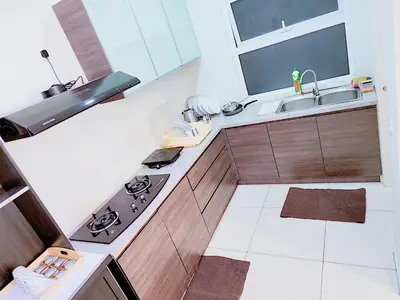 a small kitchen with a stove and a sink at The Ipoh All Suite Resort, Jalan Haven Ipoh in Ipoh