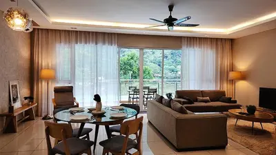 a living room with a couch and a table at The Ipoh All Suite Resort, Jalan Haven Ipoh in Ipoh