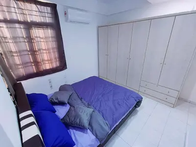 a bedroom with a bed with blue sheets and a window at Cozy 3 Bedroom Apartment Bandar Perda BM in Bukit Mertajam