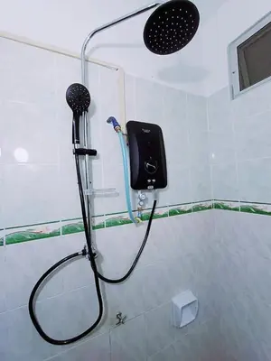 a shower in a bathroom with a blow dryer at Cozy 3 Bedroom Apartment Bandar Perda BM in Bukit Mertajam