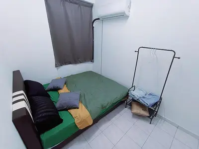 a bedroom with a bed and a mirror at Cozy 3 Bedroom Apartment Bandar Perda BM in Bukit Mertajam