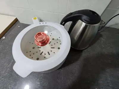 a white bowl with a red candle in it next to a pot at Cozy 3 Bedroom Apartment Bandar Perda BM in Bukit Mertajam
