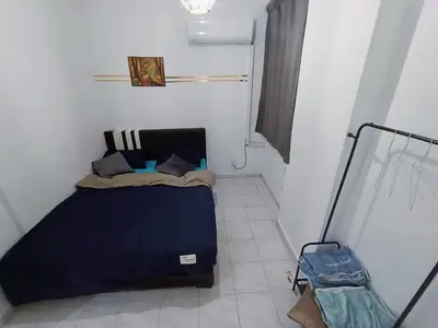 a small bedroom with a bed in a room at Cozy 3 Bedroom Apartment Bandar Perda BM in Bukit Mertajam