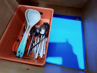 a container with utensils and a laptop on a table at Cozy 3 Bedroom Apartment Bandar Perda BM in Bukit Mertajam